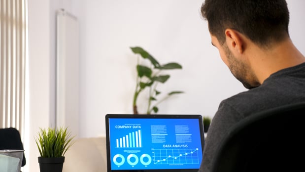 business-person-working-his-laptop-looking-chart-data-his-living-room
